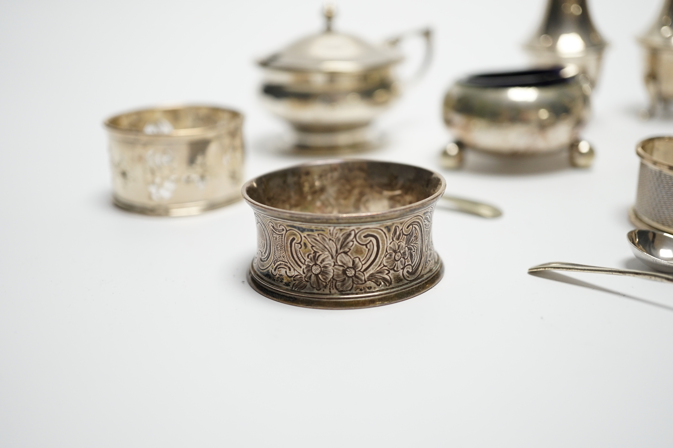 Six assorted silver cruets and three silver napkin rings.